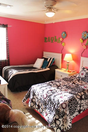 8101 Marni Trail Amarillo, TX 79110 - Photo 13 of 39 a bedroom with a bed and a potted plant