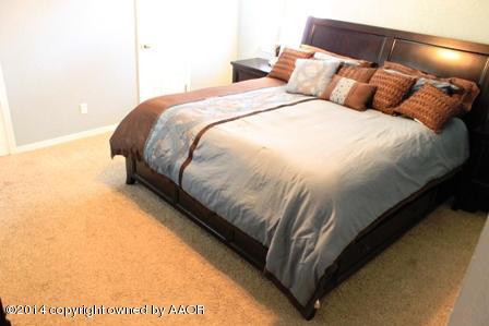 8101 Marni Trail Amarillo, TX 79110 - Photo 23 of 39 a large bed sitting in a bedroom next to a lamp