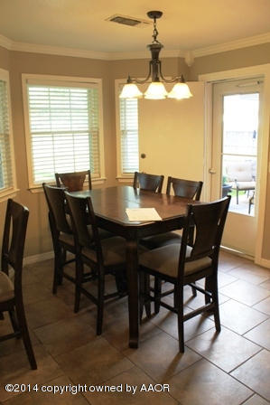 8101 Marni Trail Amarillo, TX 79110 - Photo 29 of 39 a view of a dining room with furniture and a chandelier