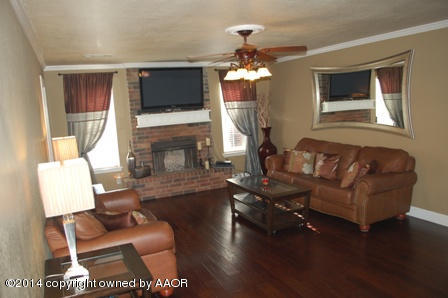 8101 Marni Trail Amarillo, TX 79110 - Photo 7 of 39 a living room with furniture a flat screen tv and a fireplace