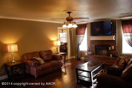 8101 Marni Trail Amarillo, TX 79110 - Photo 8 of 39 a living room with furniture a flat screen tv and a fireplace