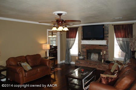 8101 Marni Trail Amarillo, TX 79110 - Photo 9 of 39 a living room with furniture a fireplace and flat screen tv