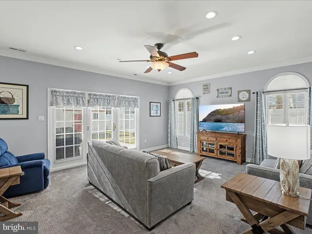 a living room with furniture flat screen tv and a fireplace
