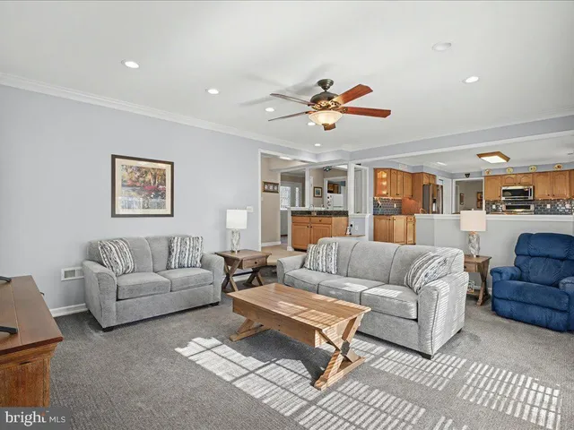 a living room with furniture a rug and a chandelier