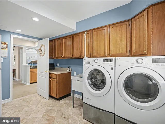a utility room with sink dryer and washer
