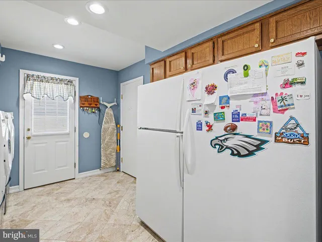 a white refrigerator freezer sitting in a kitchen