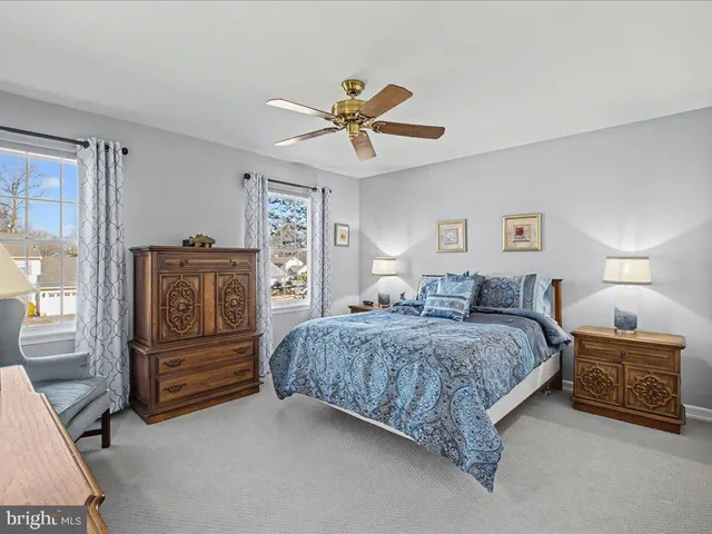 a spacious bedroom with a bed and dresser