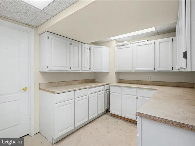 a kitchen with white cabinets