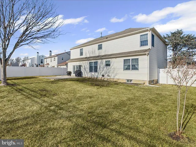a front view of house with yard and trees around