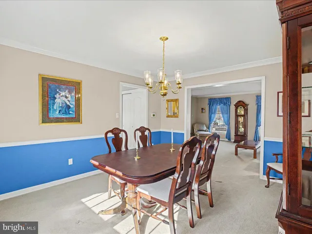 a dining room with furniture and chandelier