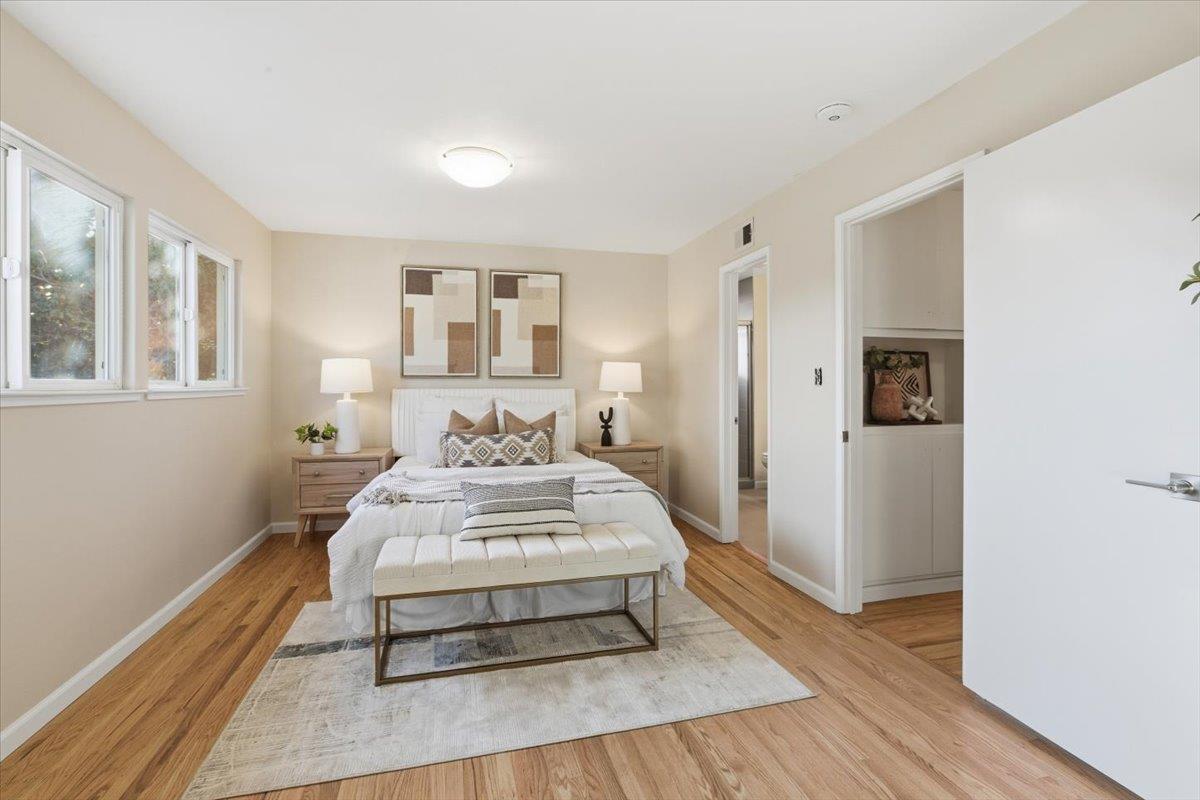 1542 Canna Court Mountain View, CA 94043 - Photo 15 of 34 a spacious bedroom with a bed and wooden floor