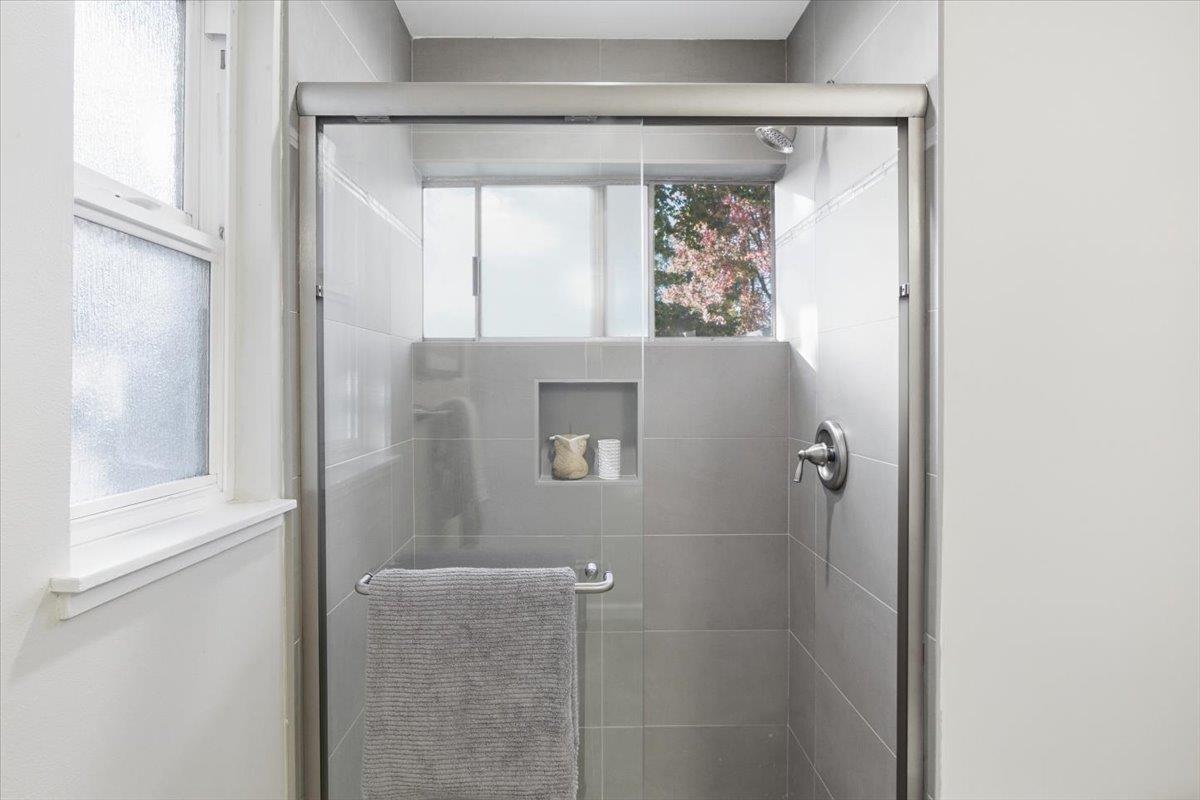 1542 Canna Court Mountain View, CA 94043 - Photo 17 of 34 a bathroom with a glass shower door and a window