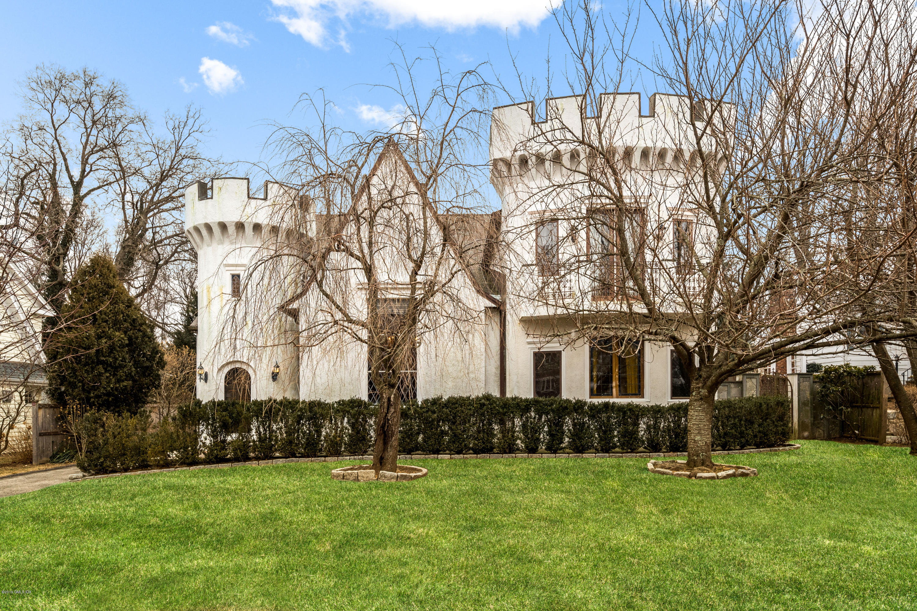 25 Oval Avenue Riverside, CT 06878 - Photo 1 of 18 a front view of a house with a yard and trees