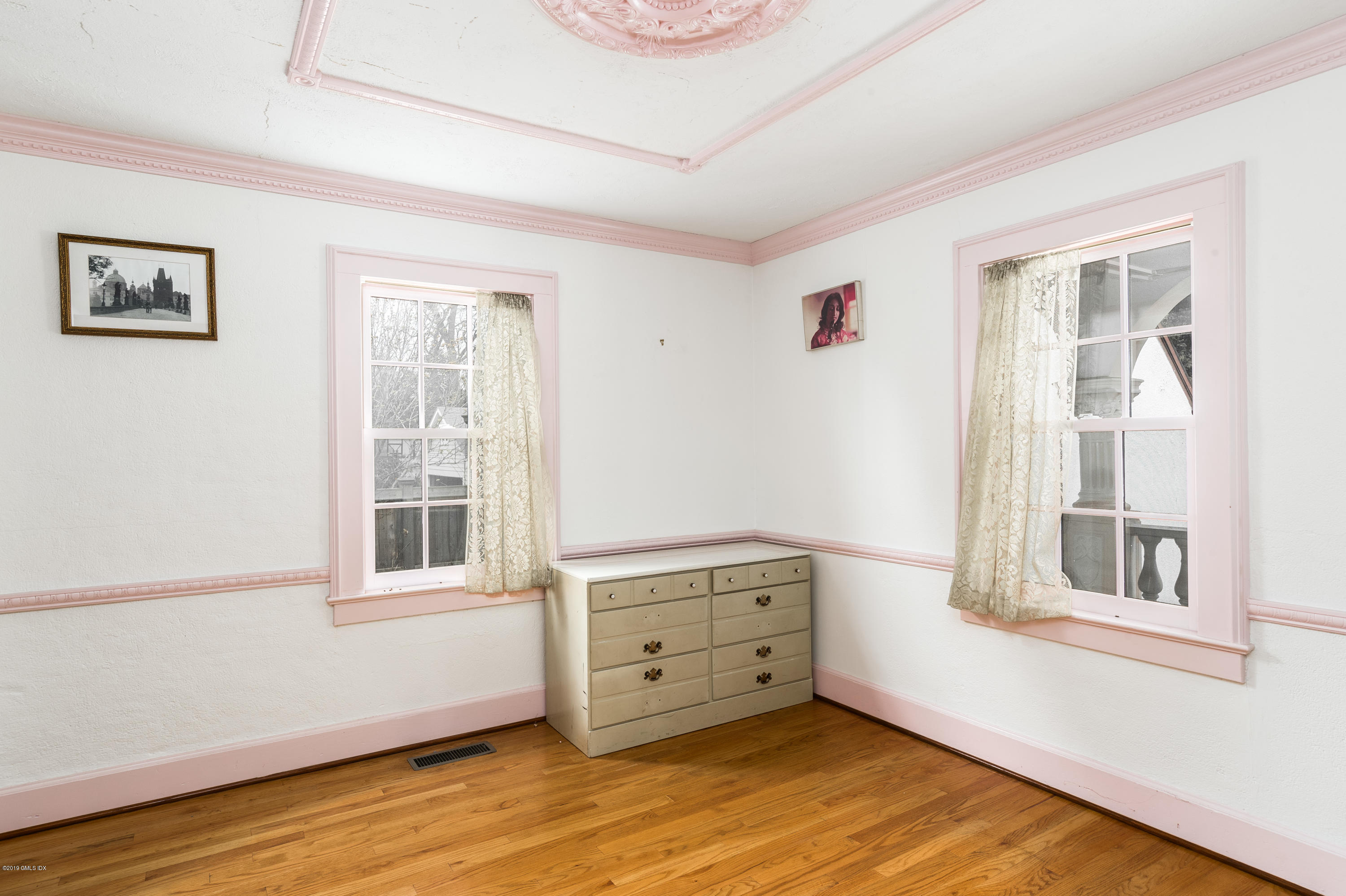 25 Oval Avenue Riverside, CT 06878 - Photo 11 of 18 a view of an empty room with a window and wooden floor