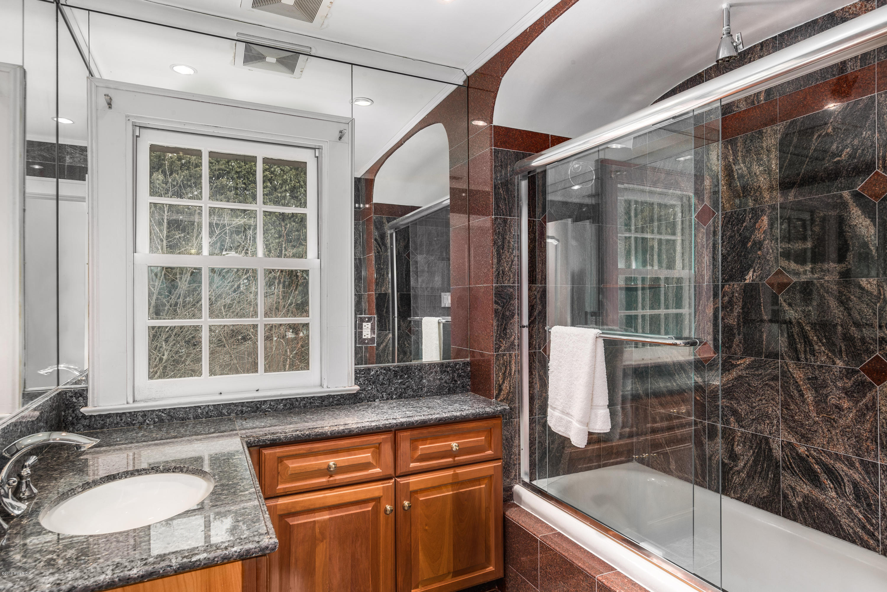 25 Oval Avenue Riverside, CT 06878 - Photo 16 of 18 a bathroom with a granite countertop sink a mirror and next to a window