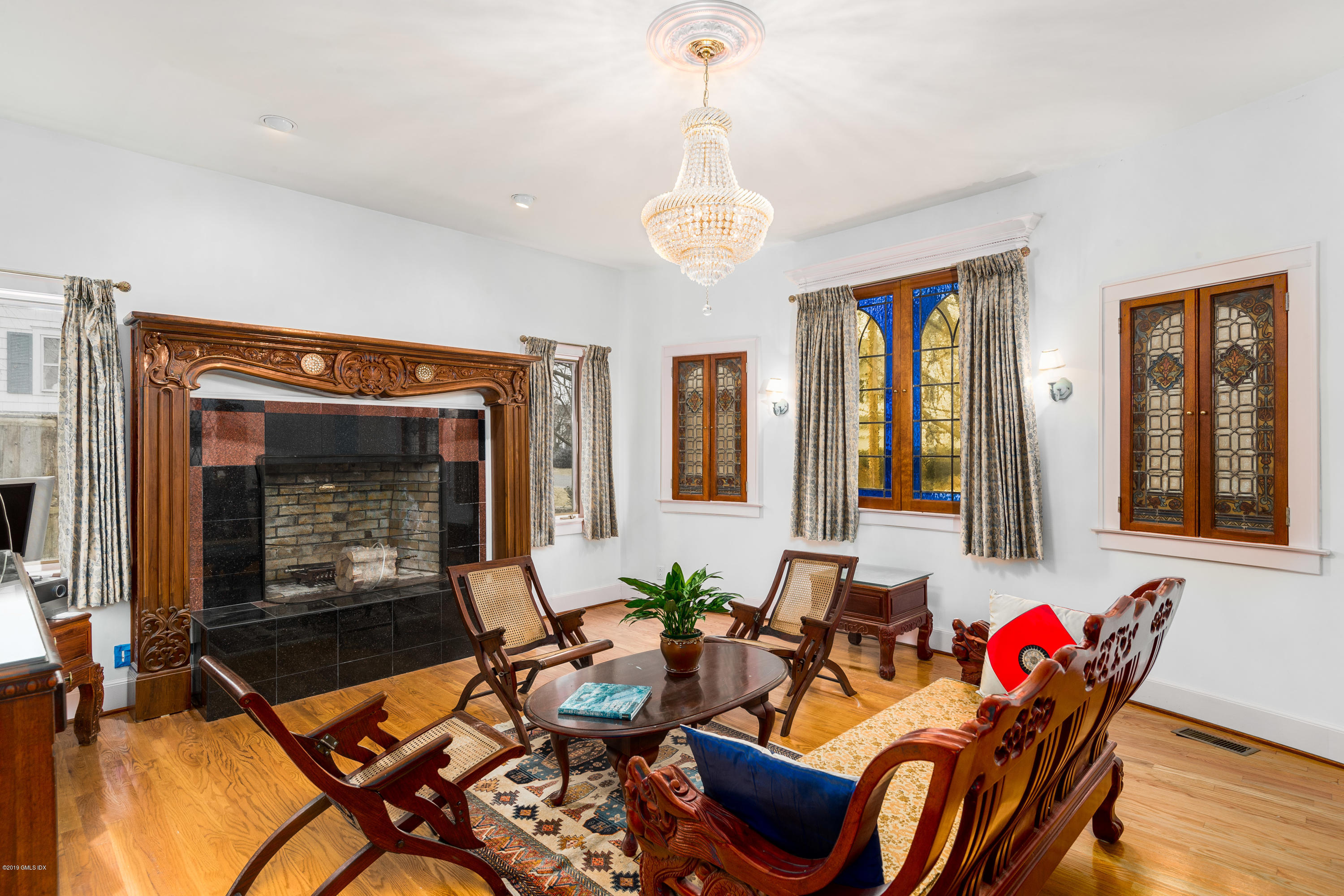 25 Oval Avenue Riverside, CT 06878 - Photo 4 of 18 a living room with furniture a fireplace and wooden floor