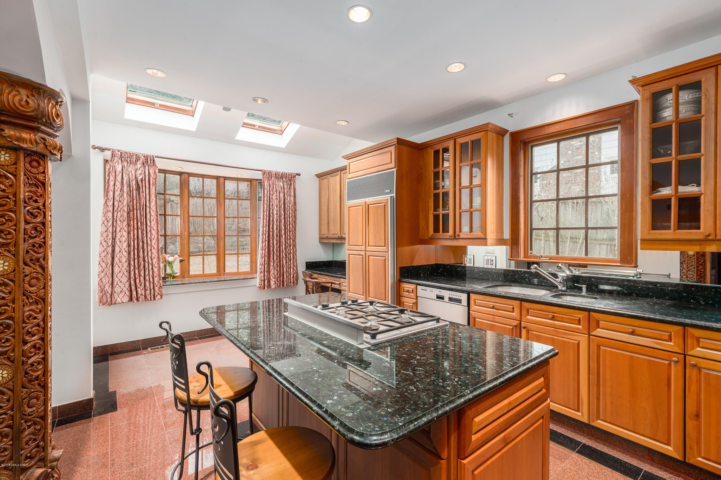25 Oval Avenue Riverside, CT 06878 - Photo 6 of 18 a kitchen with stainless steel appliances granite countertop sink stove and wooden cabinets