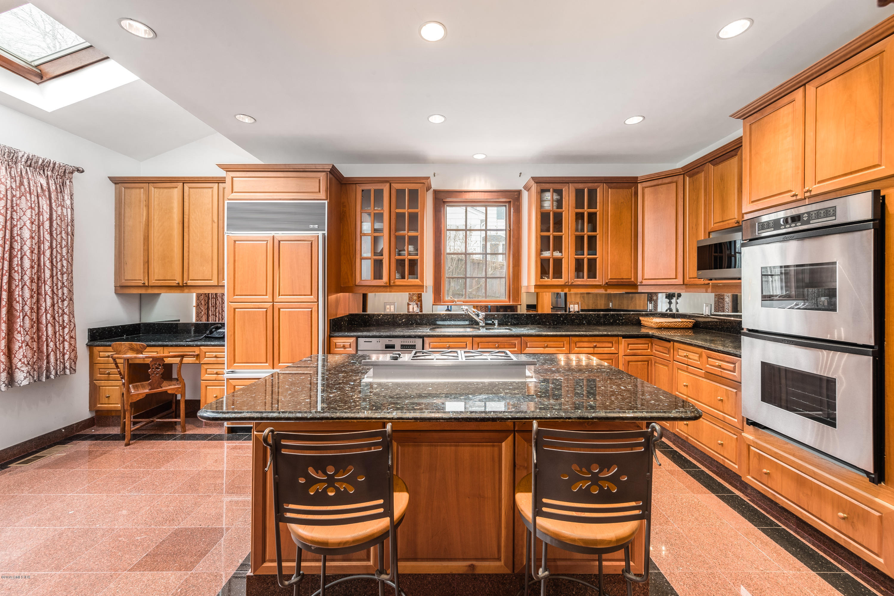 25 Oval Avenue Riverside, CT 06878 - Photo 7 of 18 a kitchen with stainless steel appliances granite countertop a stove a sink dishwasher and a microwave oven with cabinets
