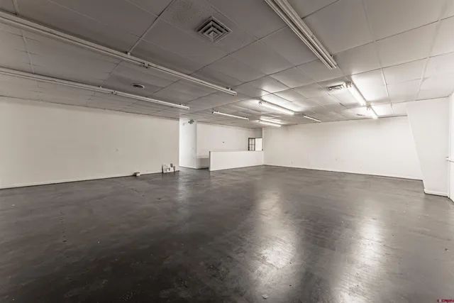 a kitchen with a table chairs appliances and cabinets