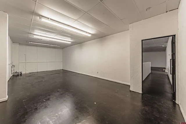 a view of a room with wooden floor