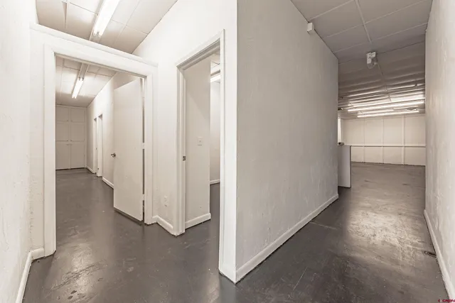 a view of hallway with stairs and wooden floor