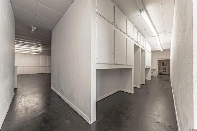 a view of a room with wooden floors and lots of racks