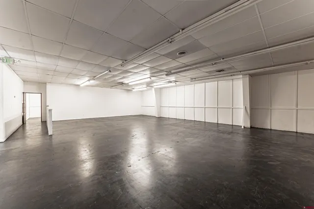 a living room with lots of furniture and white walls