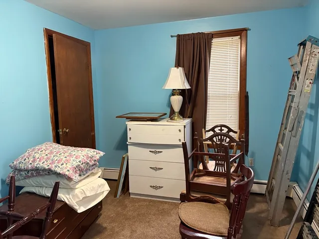 a bedroom with a bed and a furniture