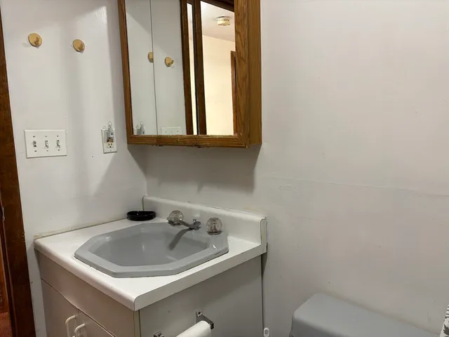 a bathroom with a sink and mirror