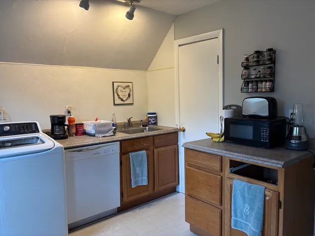 a kitchen with stainless steel appliances a sink stove and cabinets
