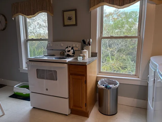 a kitchen with a stove and a window