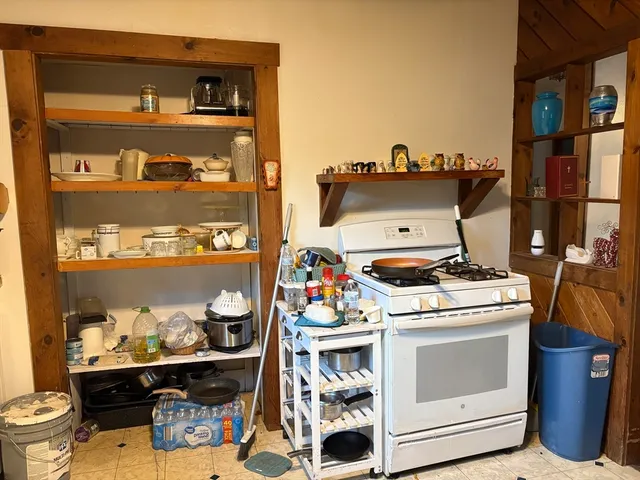 a utility room with a stove and cabinets
