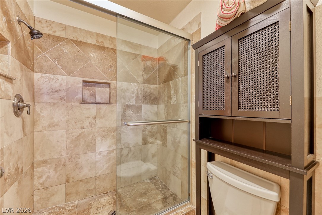 2001 Appaloosa Road Henderson, NV 89002 - Photo 34 of 44 This bathroom offers a glass-enclosed shower with elegant tile work.
