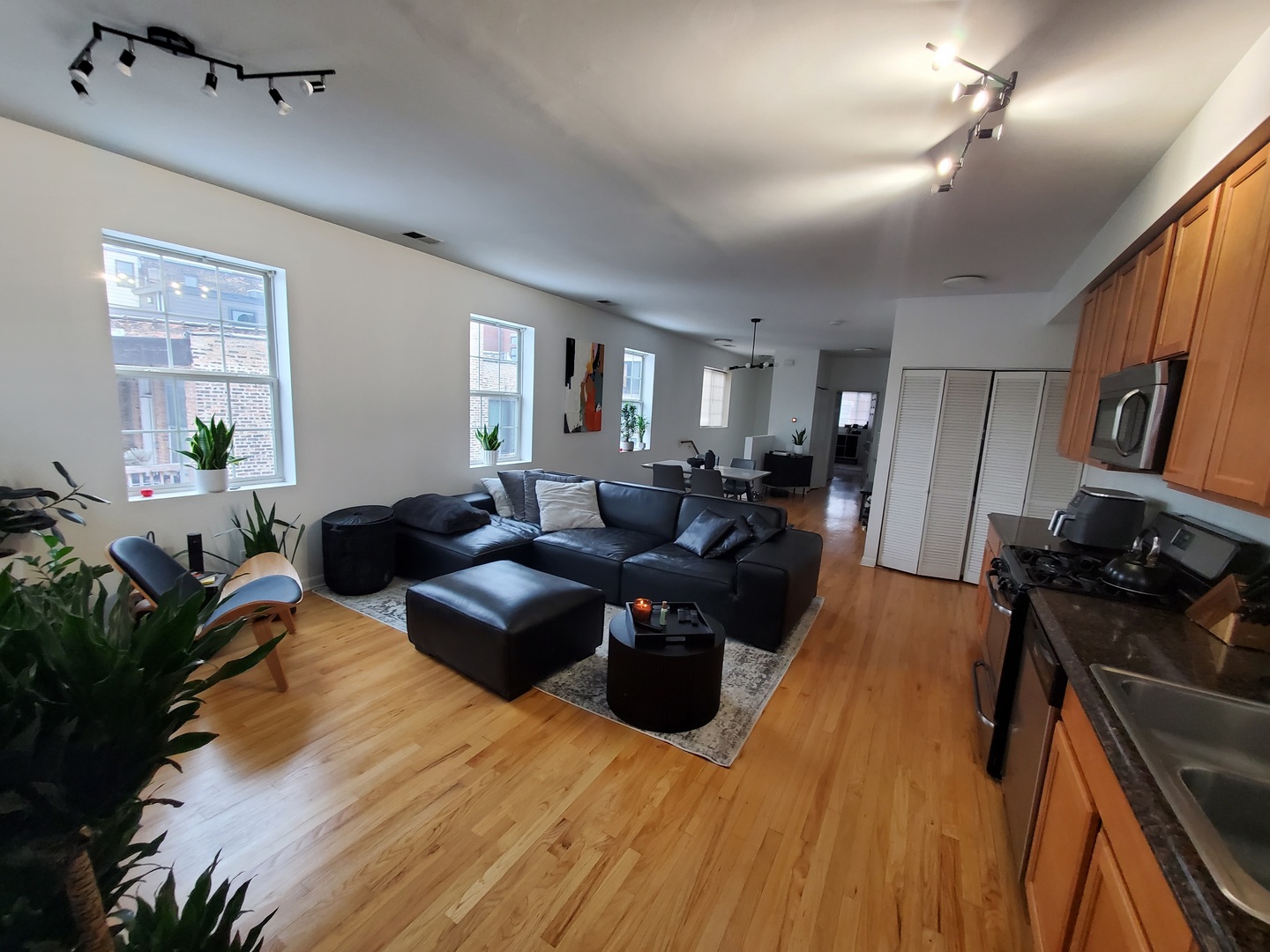 2014 West Superior Street, Unit 2 Chicago, IL 60612 - Photo 3 of 11 a living room with furniture a flat screen tv and a refrigerator