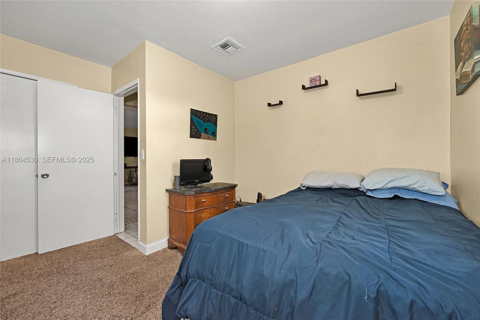 1220 Northwest 88th Street Miami, FL 33147 - Photo 15 of 31 a bedroom with a bed and wooden floor