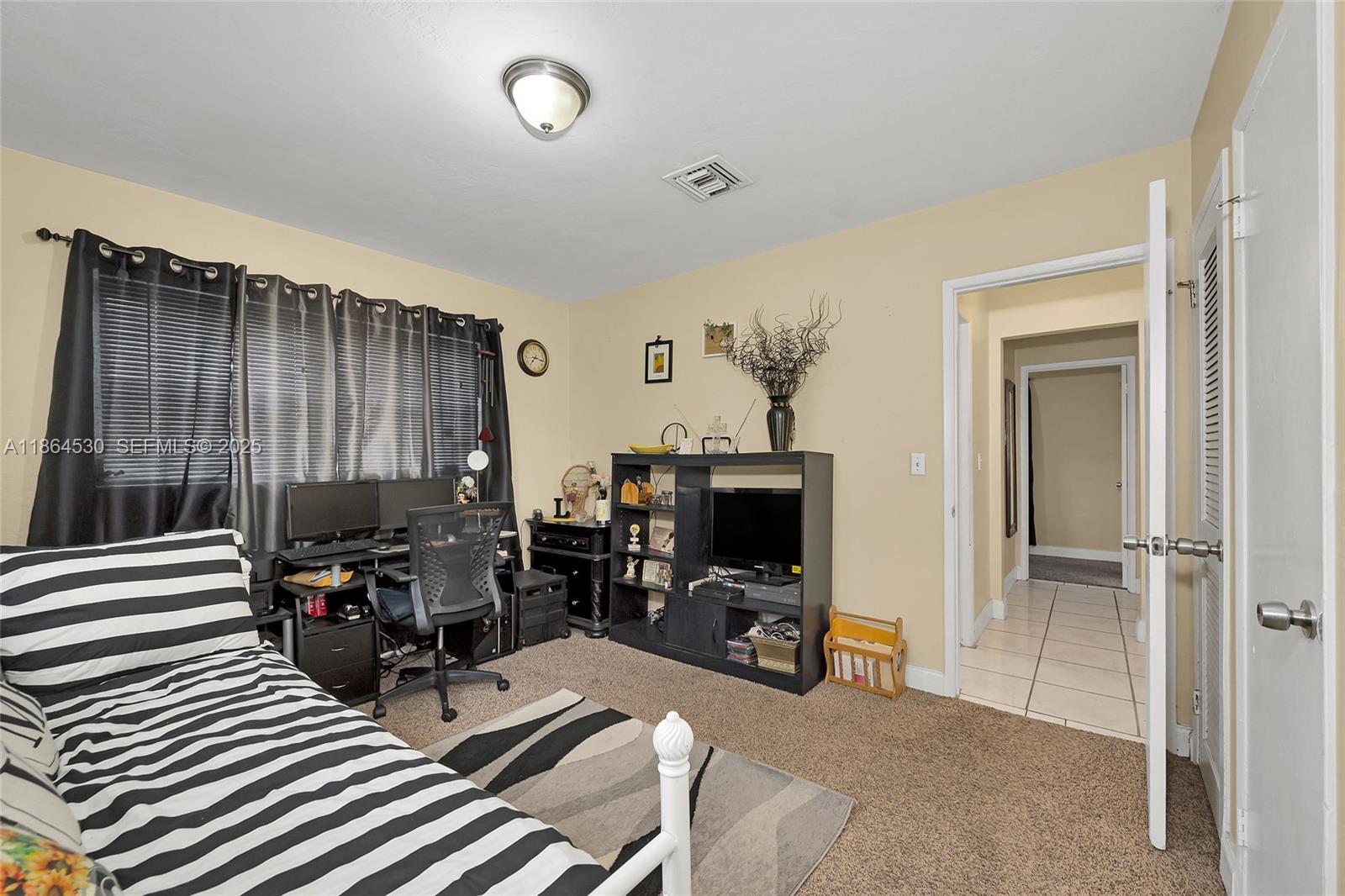 1220 Northwest 88th Street Miami, FL 33147 - Photo 18 of 31 a view of a livingroom with workspace and a window