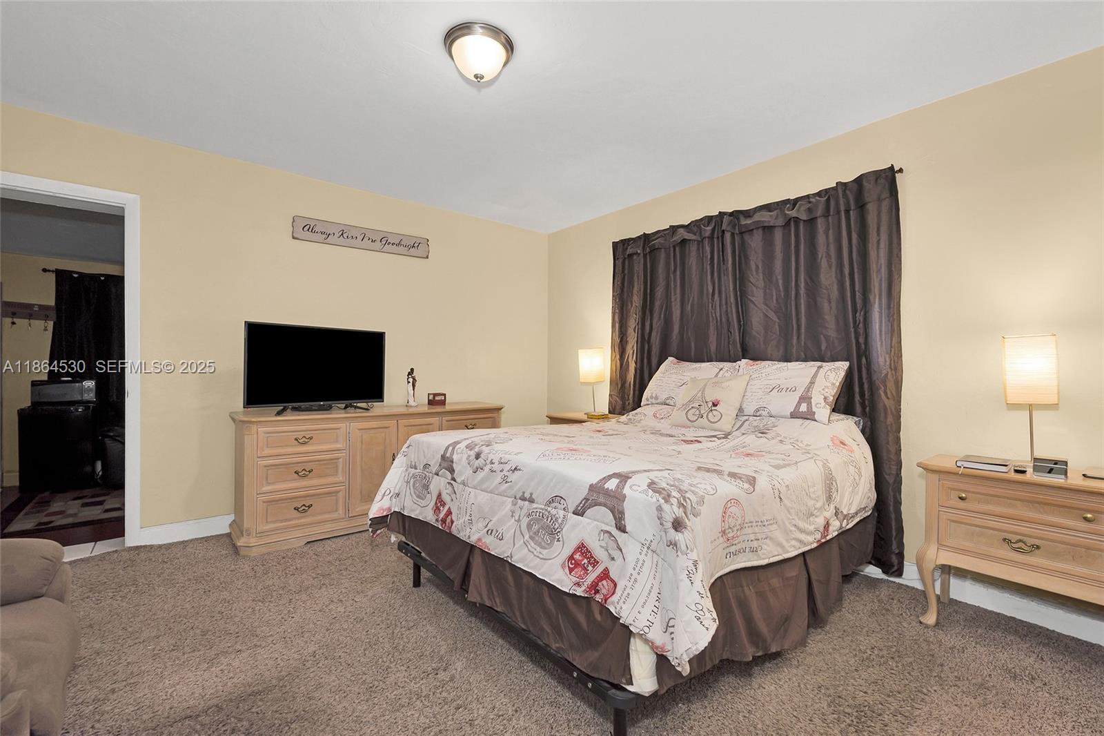 1220 Northwest 88th Street Miami, FL 33147 - Photo 20 of 31 a bedroom with a bed and a flat screen tv