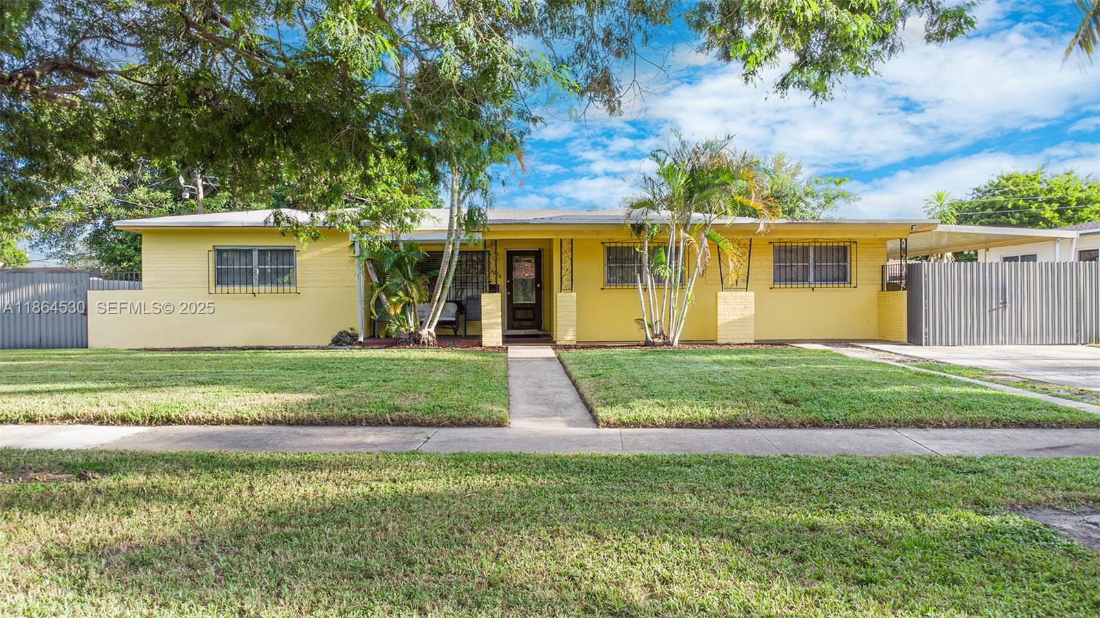 1220 Northwest 88th Street Miami, FL 33147 - Photo 2 of 31 front view of a house with a yard