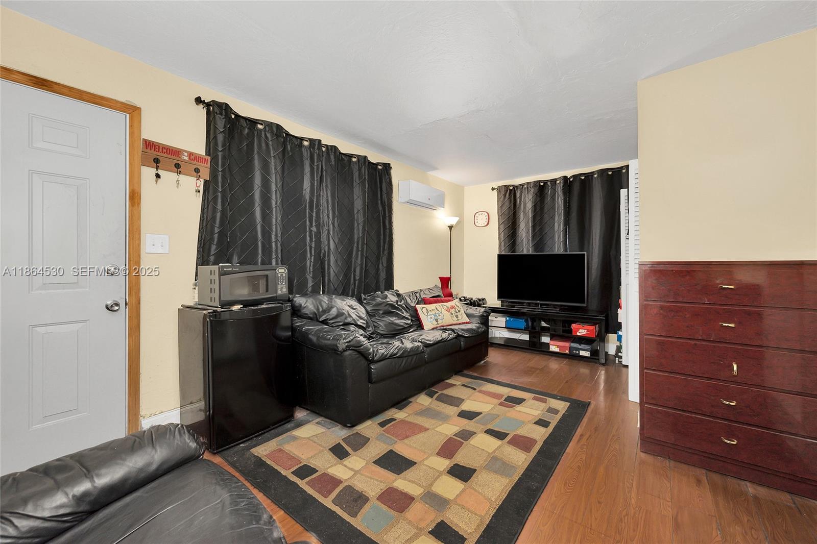 1220 Northwest 88th Street Miami, FL 33147 - Photo 23 of 31 a living room with furniture and a flat screen tv