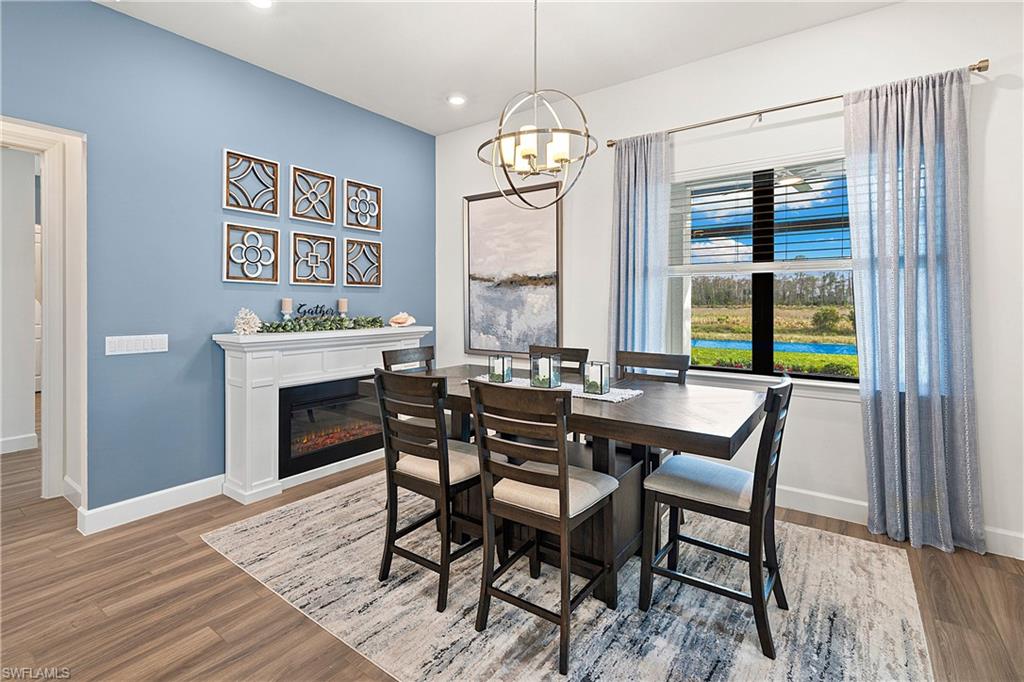 20549 Napa Loop Estero, FL 33928 - Photo 11 of 50 a view of a dining room with furniture window and wooden floor