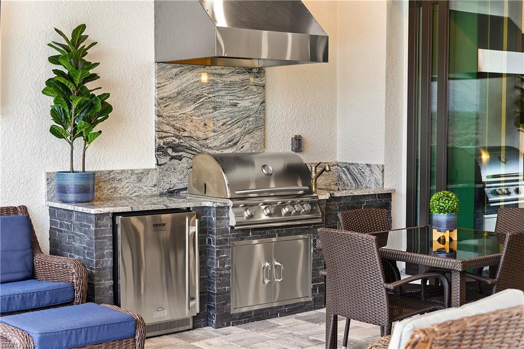 20549 Napa Loop Estero, FL 33928 - Photo 15 of 50 a kitchen with a table chairs and potted plant