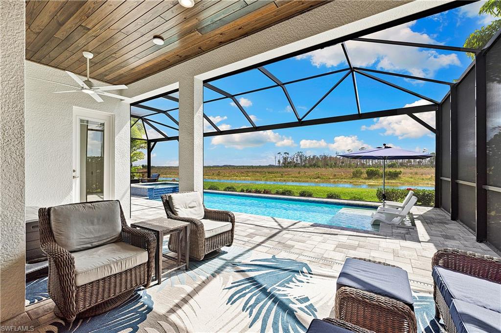 20549 Napa Loop Estero, FL 33928 - Photo 16 of 50 a roof deck with table and chairs under an umbrella