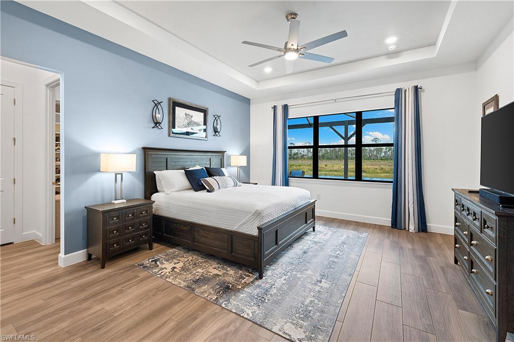 20549 Napa Loop Estero, FL 33928 - Photo 23 of 50 a bedroom with a large bed and a tv