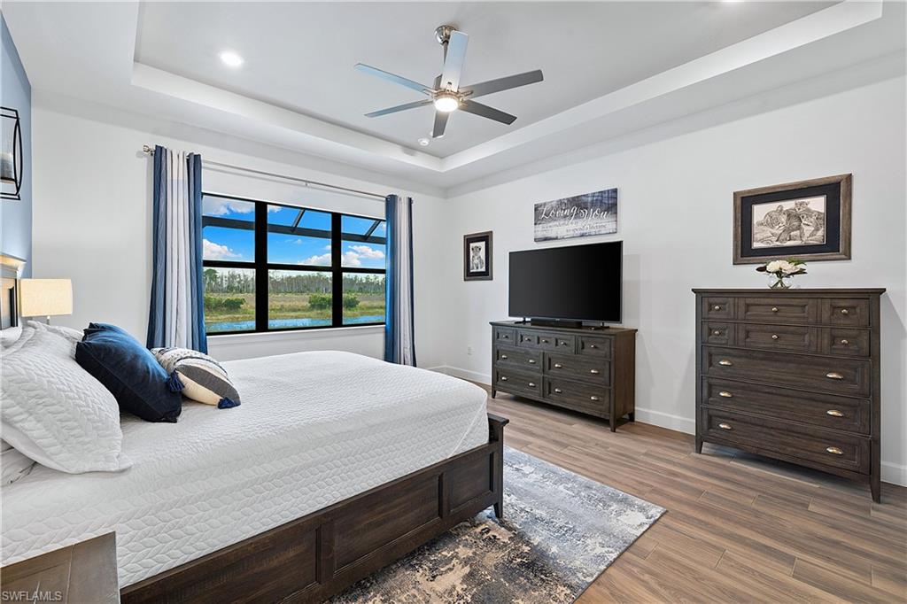20549 Napa Loop Estero, FL 33928 - Photo 27 of 50 a bedroom with a bed and a flat screen tv