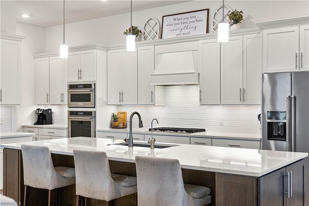 20549 Napa Loop Estero, FL 33928 - Photo 30 of 50 a kitchen with stainless steel appliances a sink stove and refrigerator