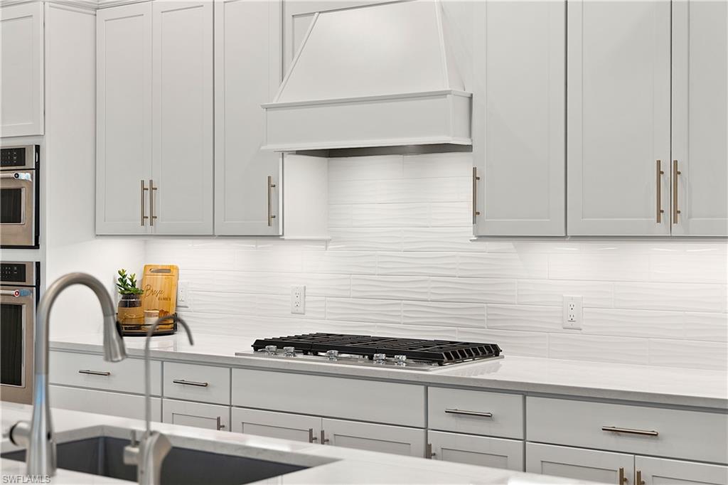 20549 Napa Loop Estero, FL 33928 - Photo 31 of 50 a kitchen with white cabinets and appliances