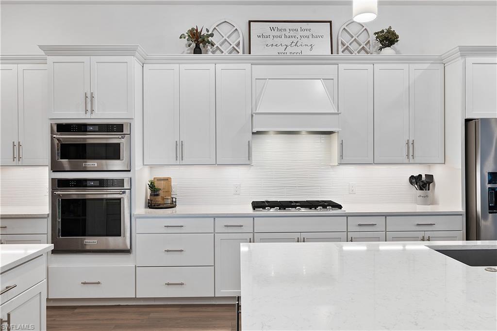 20549 Napa Loop Estero, FL 33928 - Photo 32 of 50 a kitchen with white cabinets and appliances