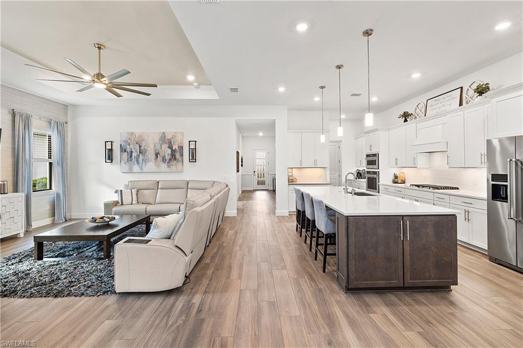 20549 Napa Loop Estero, FL 33928 - Photo 33 of 50 a large kitchen with stainless steel appliances kitchen island granite countertop a large center island attached withe living room