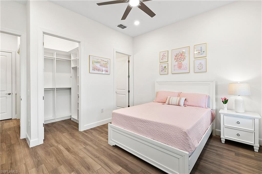 20549 Napa Loop Estero, FL 33928 - Photo 38 of 50 a bedroom with a bed and a chandelier