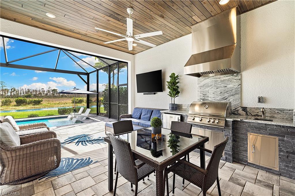 20549 Napa Loop Estero, FL 33928 - Photo 4 of 50 a dining room with furniture and a flat screen tv